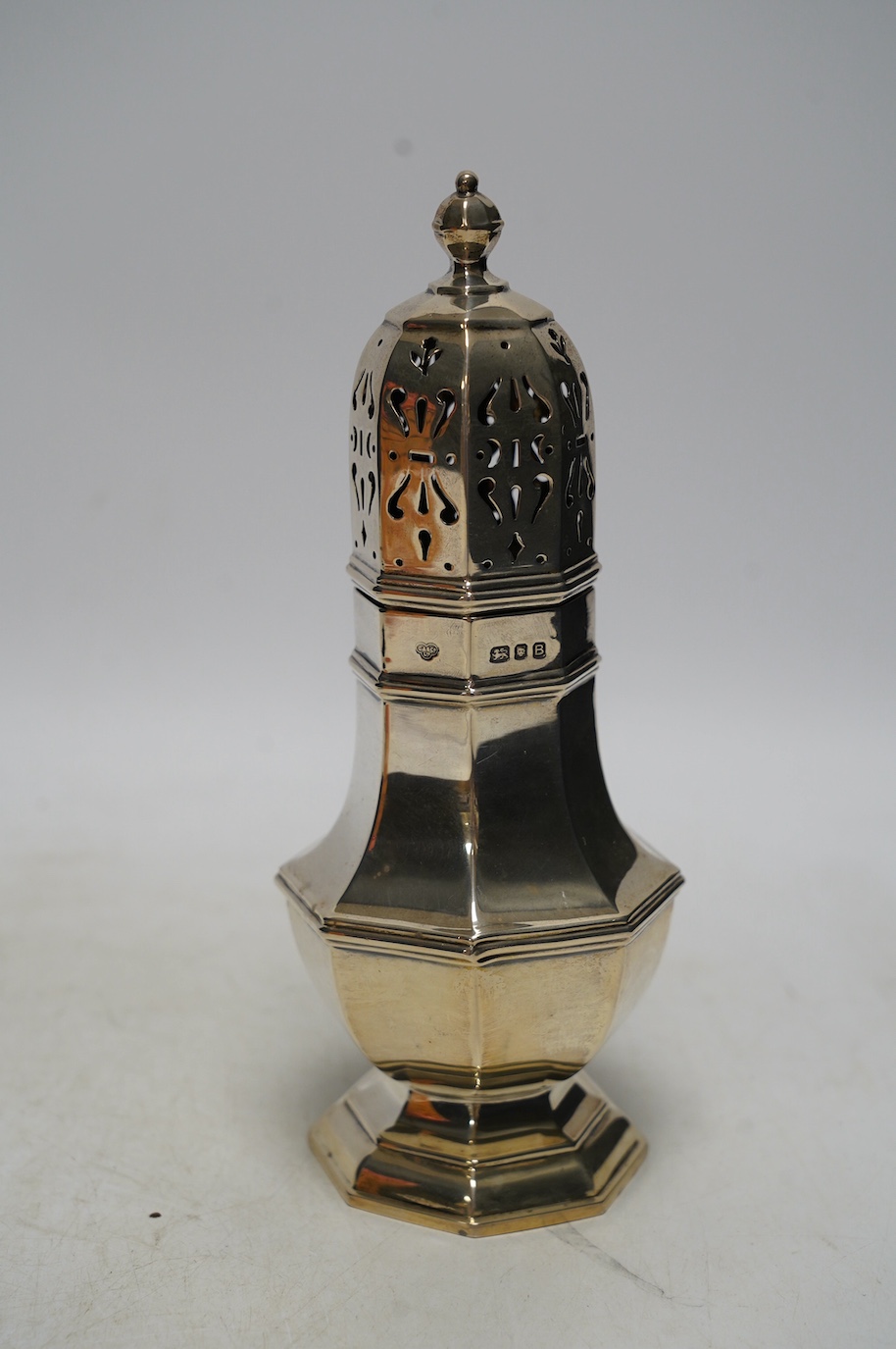 A George VI silver octagonal sugar caster, Goldsmiths & Silversmiths Co Ltd, London, 1937, 21cm, 8.7oz. Condition - fair to good